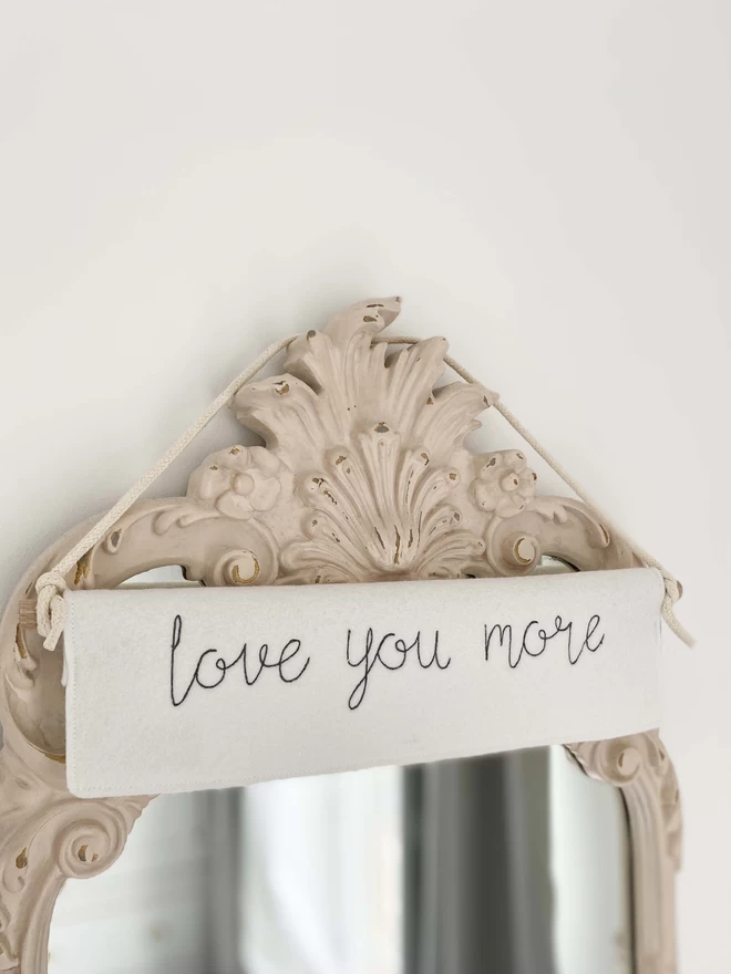 Love You More Felt Embroidered Banner on mirror