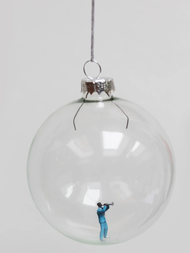 Miniature figure of a jazz trumpet player in a glass Christmas bauble