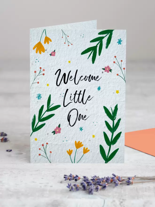 'Welcome Little One' New Baby Plantable Card with Floral Illustrations standing up with Lavender in front