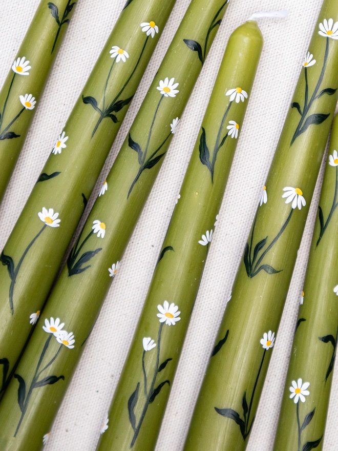 Hand painted olive daisy candles by Tired Starling Studio