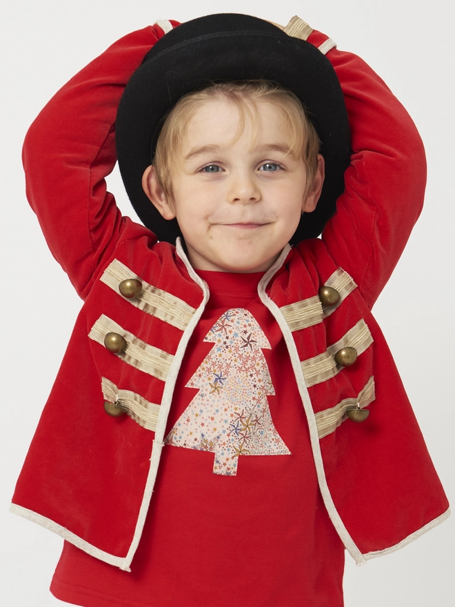 a 4 year old boy wearing a top hat and a festive red tee with a christmas tree cut from starry Adeljada liberty print sewn onto the front