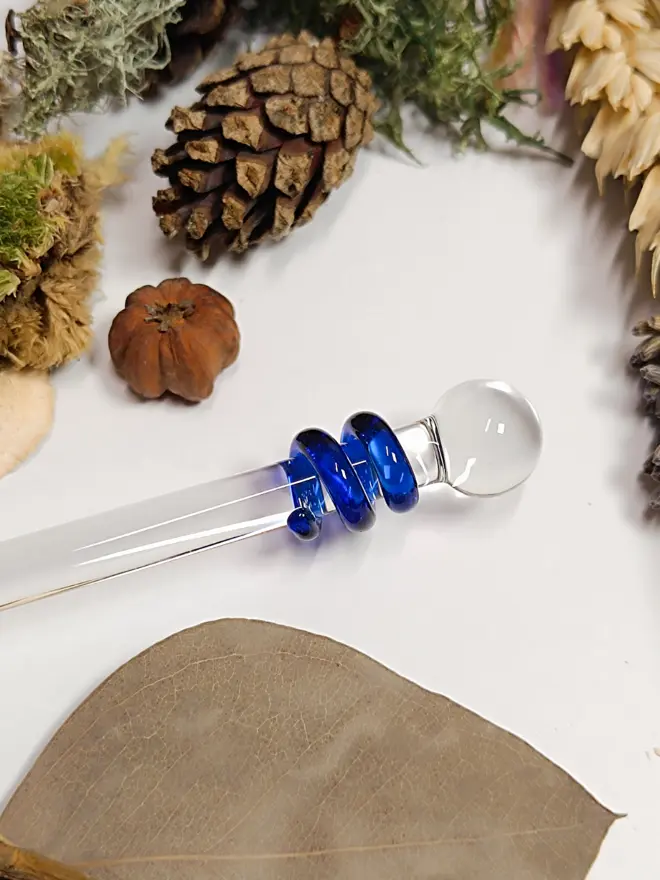 Close up of the decoration on a glass drinks stirrer