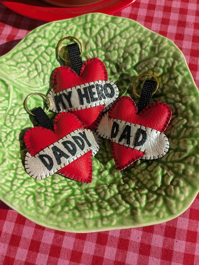 Red tattoo style heart keyrings with the words, Dad, daddy and my hero