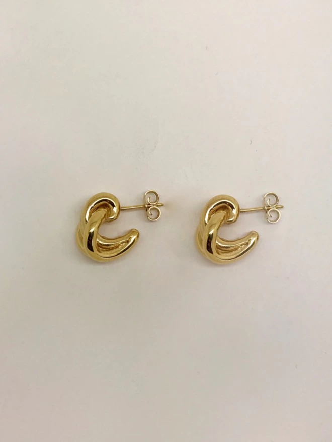 understated contemporary gold hoops with a knotted huggie design
