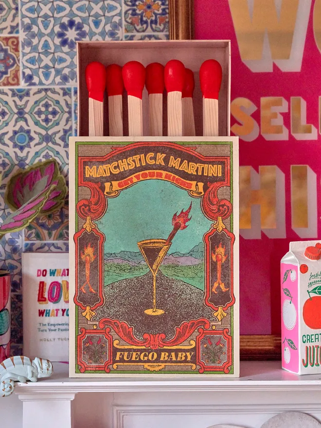 Personalised oversized matchbox. A large matchbox with a printed front on a mantlepiece 