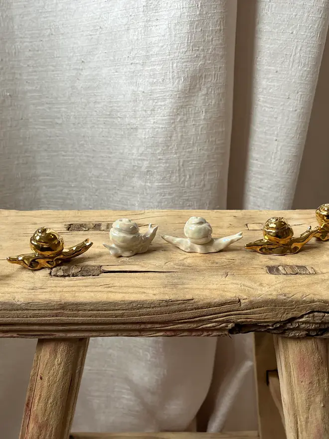 ceramic snails on wooden stool