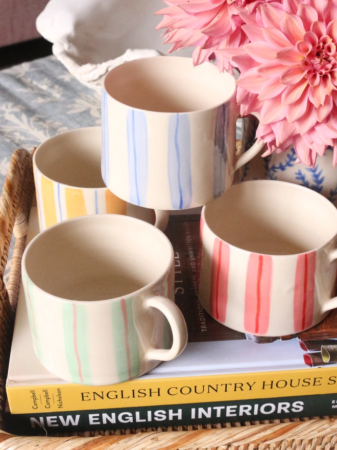green and pink, blue, yellow and blue hand painted striped ceramic coffee cup