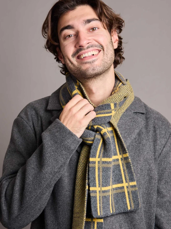 Grey And Yellow Patterned Wool Scarf Modelled By A Man In A Grey Coat