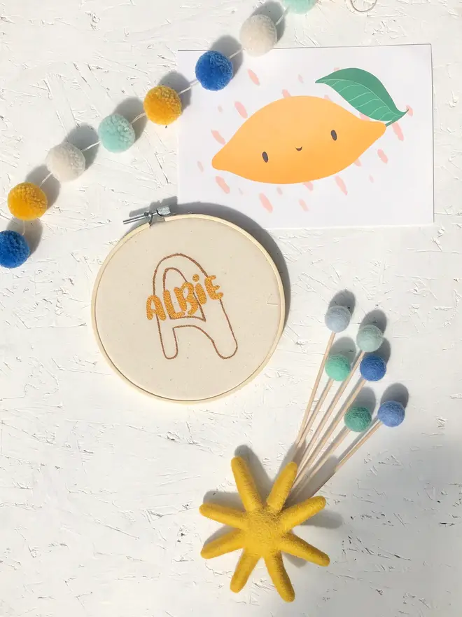 personalised name and initial embroidered hoop. cotton hoop embroidered with name alfie and initial a.