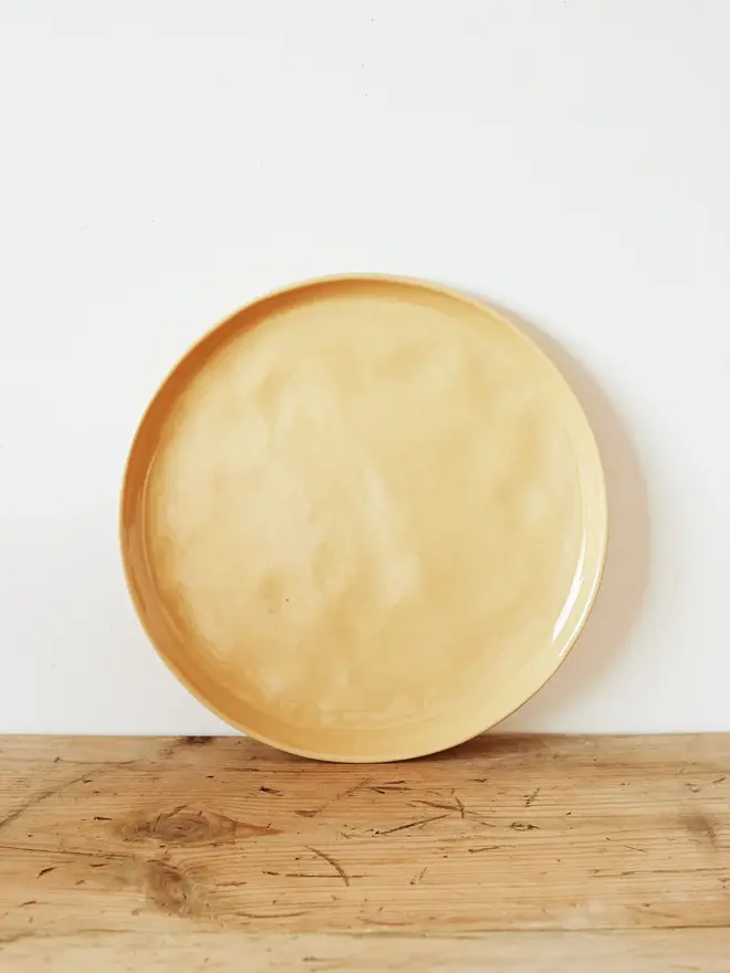 large stoneware plates (set of 2). a large round plate in yellow.