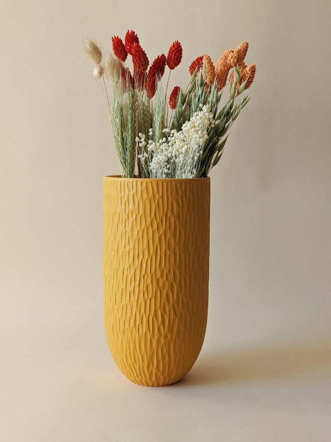 handmade textured yellow vase with dried flowers