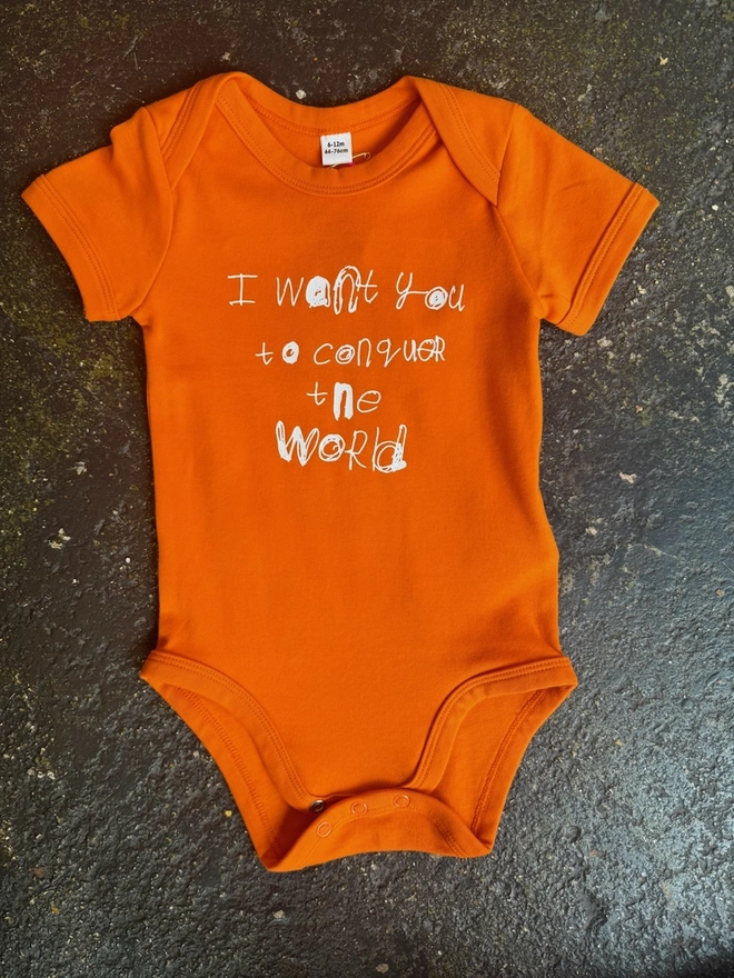 Orange baby grow with Pipers white unique font