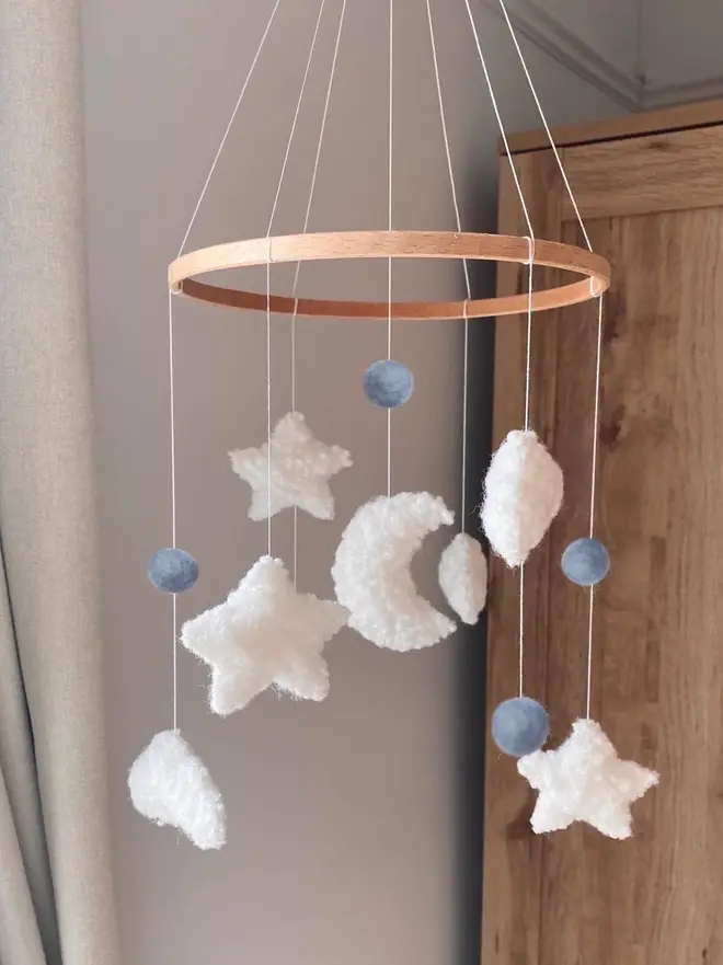'sweet dreams' boucle baby mobile. a baby mobile hanging from the ceiling with moons, stars and clouds.