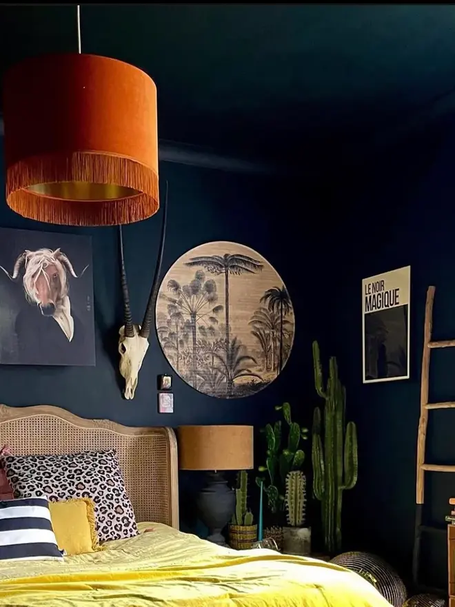 Rust Velvet Lampshade With Gold Lining & Fringing, in a room. 