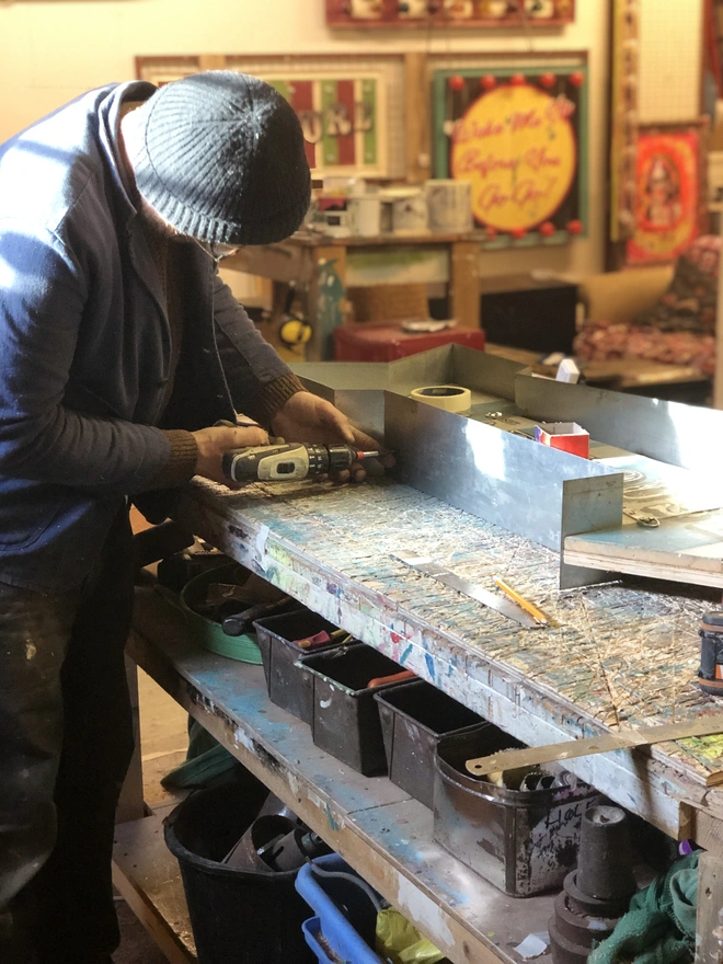 Dusty maker of vinatge fairground circus signs for Argent and Sable Making Mad House Light Up Sign 