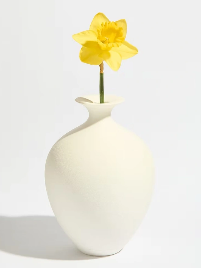 urn shaped white 3d printed vase with yellow flower