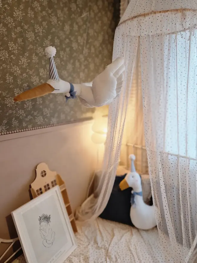Circus Swan Hanging Decoration, a hanging swan decoration suspended in a child's bedroom. 