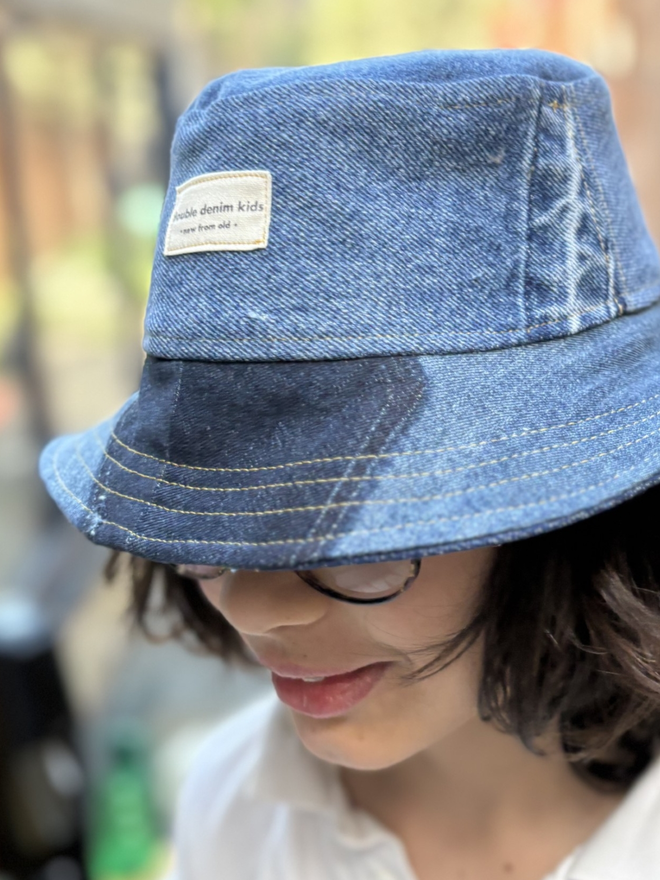Handmade kids’ bucket hat sewn from reclaimed denim in assorted blue washes, sustainable and one‑of‑a‑kind