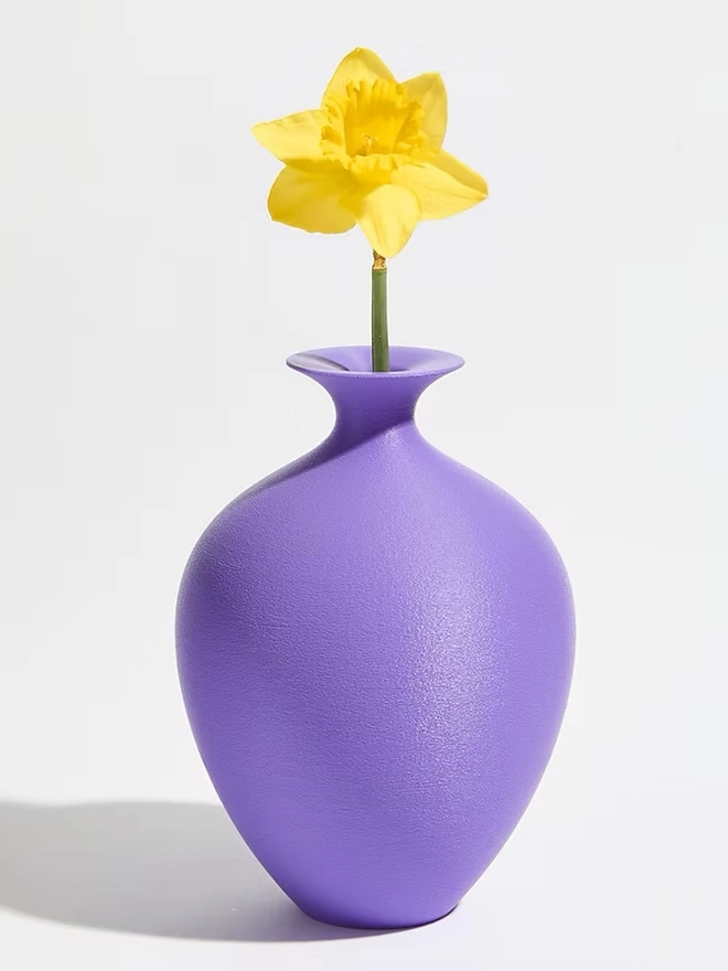 round urn shaped 3d printed vase in purple with yellow flower
