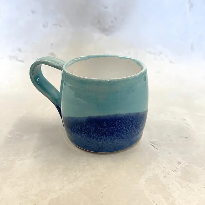 Landscape Large Round Mug, a colourful coffee mug on a stone surface. 