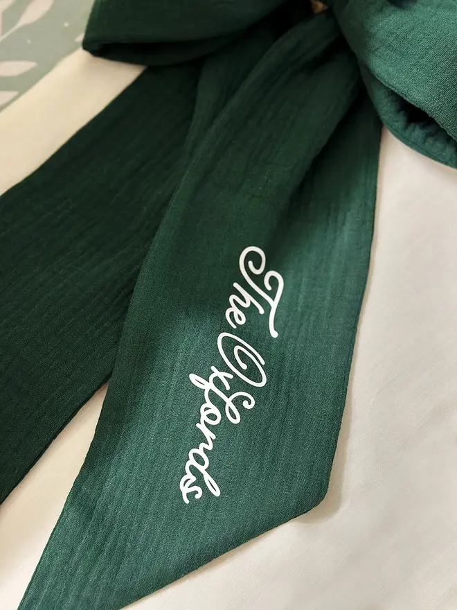 A handmade forest green Christmas bow made from double gauze cotton fabric.