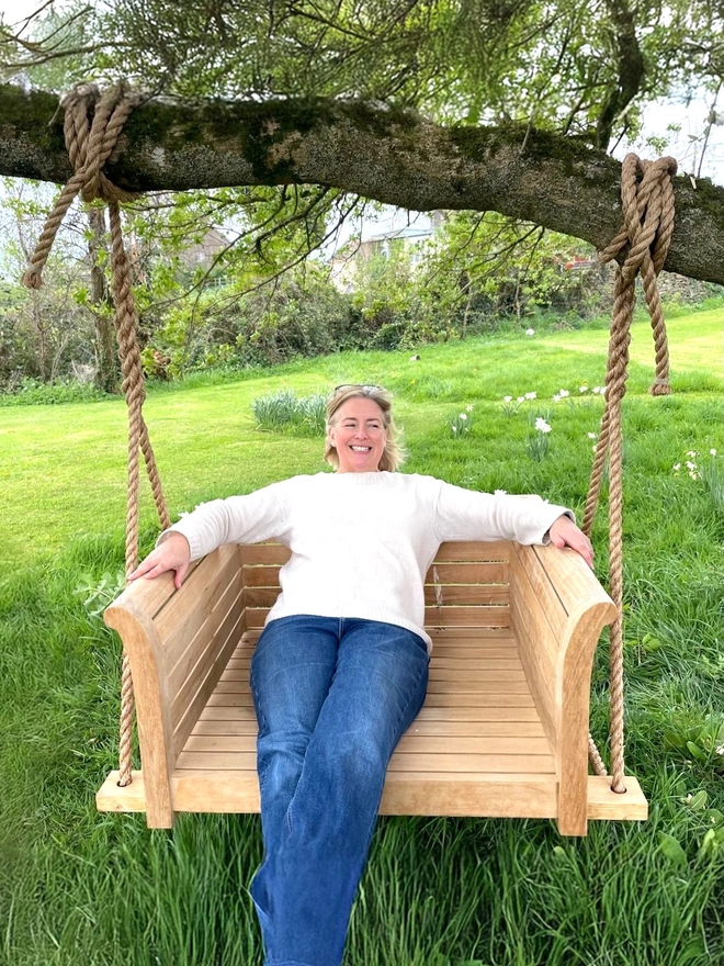 Happy customer sat on Snuggle Swing Bench