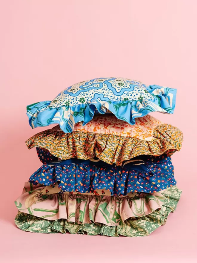 Frilly Fancy In Cornflower in a stack of pillows
