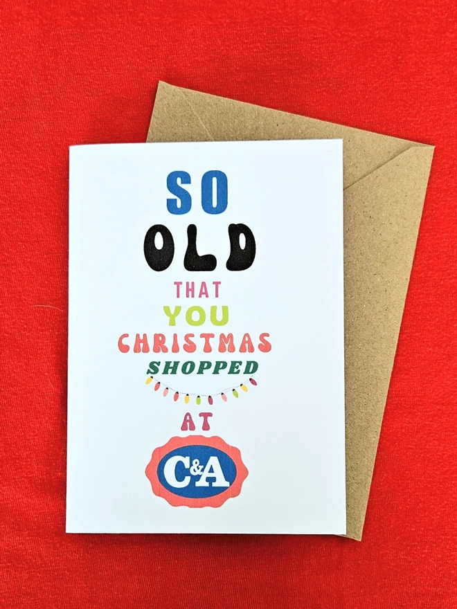 A photograph of the front of a humorous A6 greeting card illustrated using brightly coloured text and the retro shop logo. The text says so old you Christmas shopped at C&A