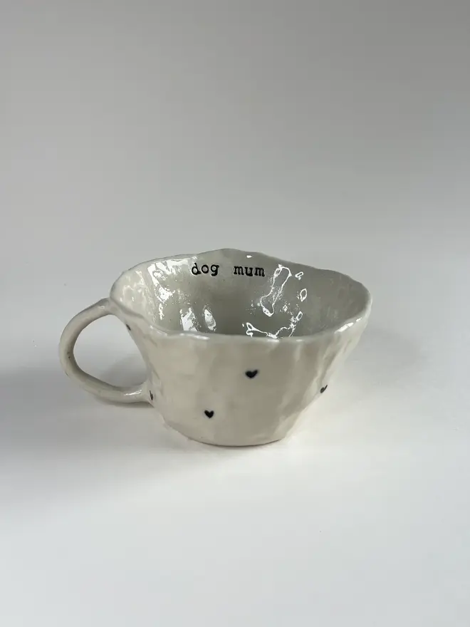 'Dog Mum' Favourite Pawprint Mug, positioned on table. 
