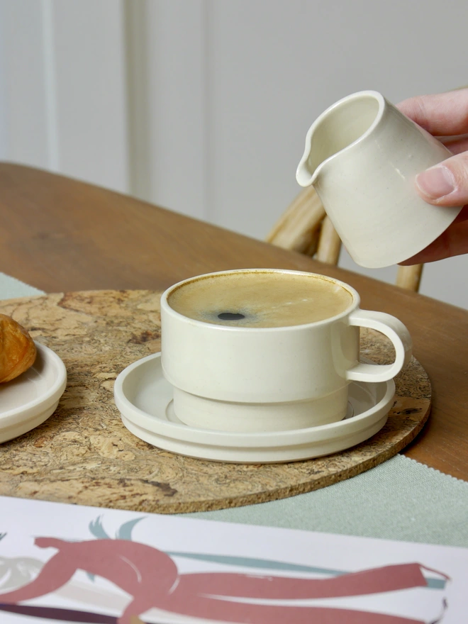 Ceramic Milk Jug in white being used