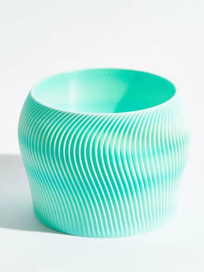 Sustainable 3D Printed Sky Blue Plant Pot, orbital design against a white background.
