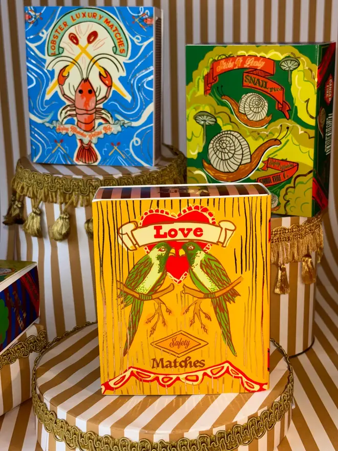 yellow matchbox with lovebird design