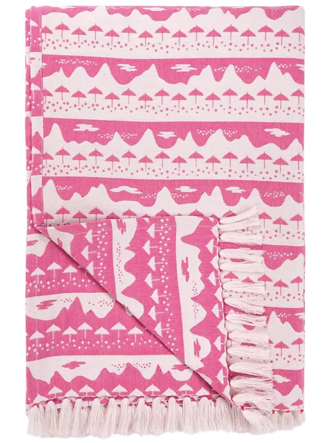 Pink Belle Mare Woven Throw, a pink throw sitting on a white surface. 