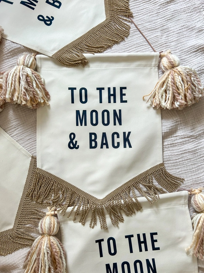 to the moon and back handmade fabric banner with tassels and gold trim