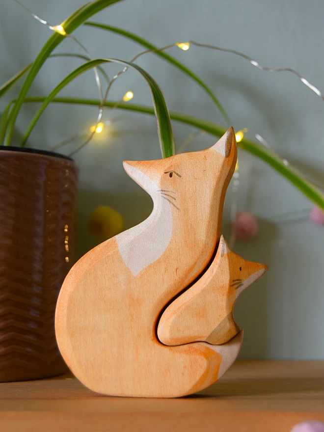 wooden toy snuggling fox pair on shelf