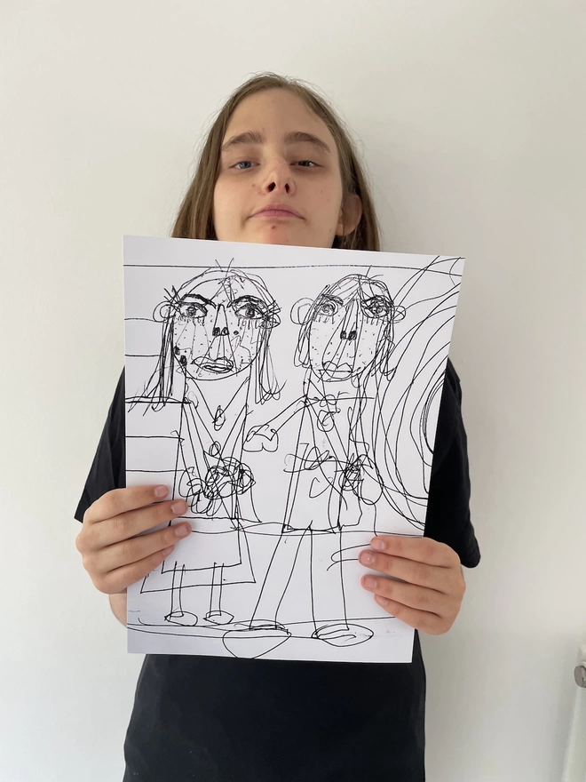Piper holding up her a4 digital print of her black line drawing of her and Tony.  There are lots of lines drawn over and over each other and each pf the people have long eyelashes and in pipers words beauty dots all over their faces.
