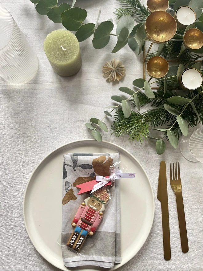 Hand-iced Christmas biscuits featuring a Nutcracker and a present in a festive gift box, available in Vanilla or Gingerbread flavour.