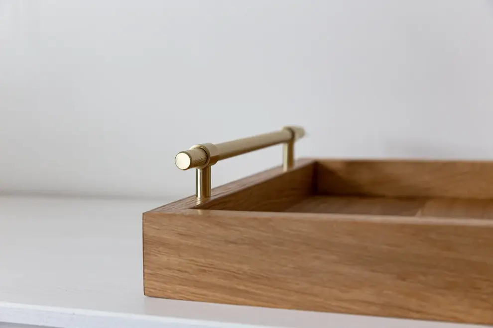 Oak and Brass Serving Tray, a wooden serving tray sat on a plain surface against a white backdrop. 