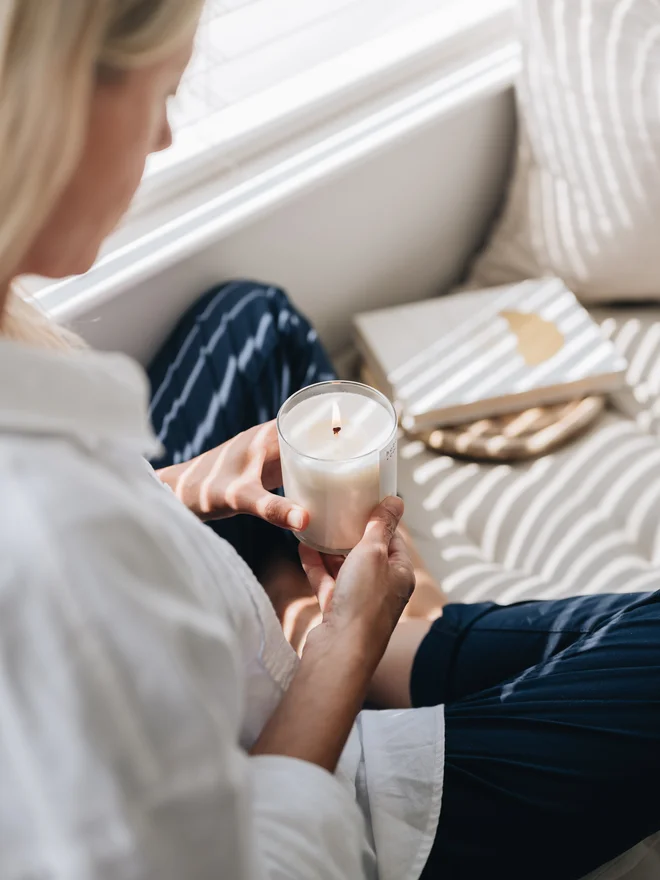 fig and cassis candle lit held in hands