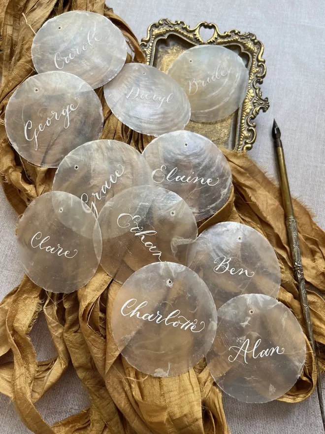 Capiz shell place settings written by hand in white ink