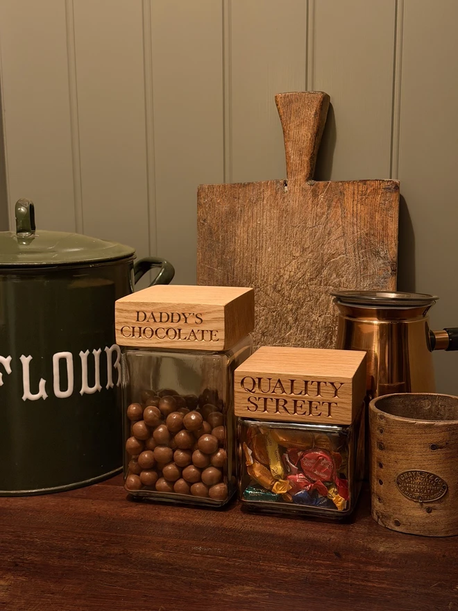 Personalised oak chocolate jar. A glass jar of chocolate balls with an oak lid engraved DADDY'S CHOCOLATE.