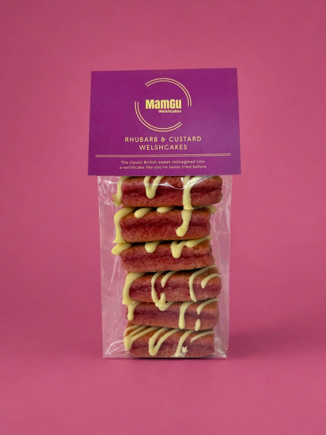 pack of Rhubarb and Custard welsh cakes with a pink label and a pink background