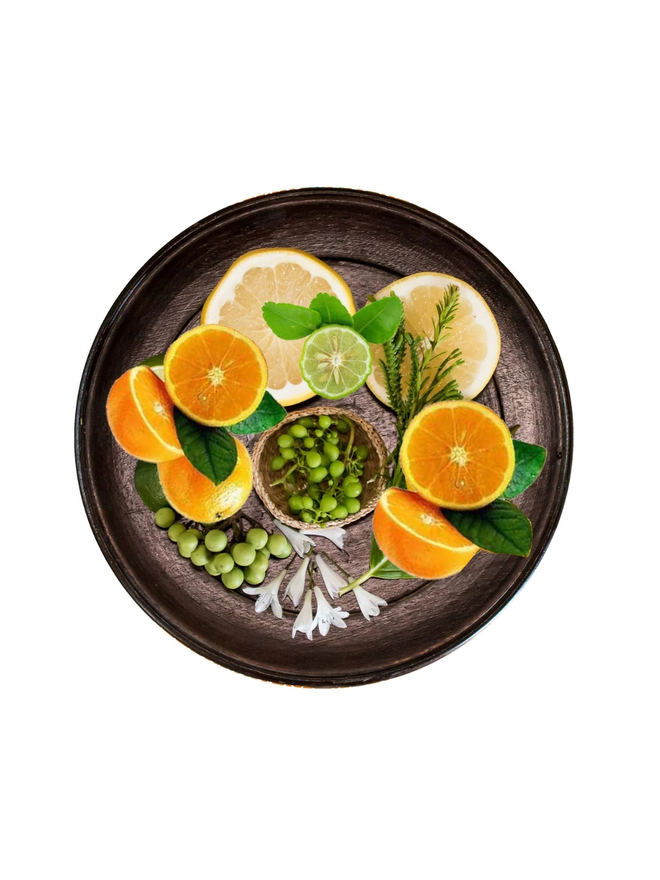 mandarin and sicilian bergamot natural wax candle. a round tray holding natural ingredients.