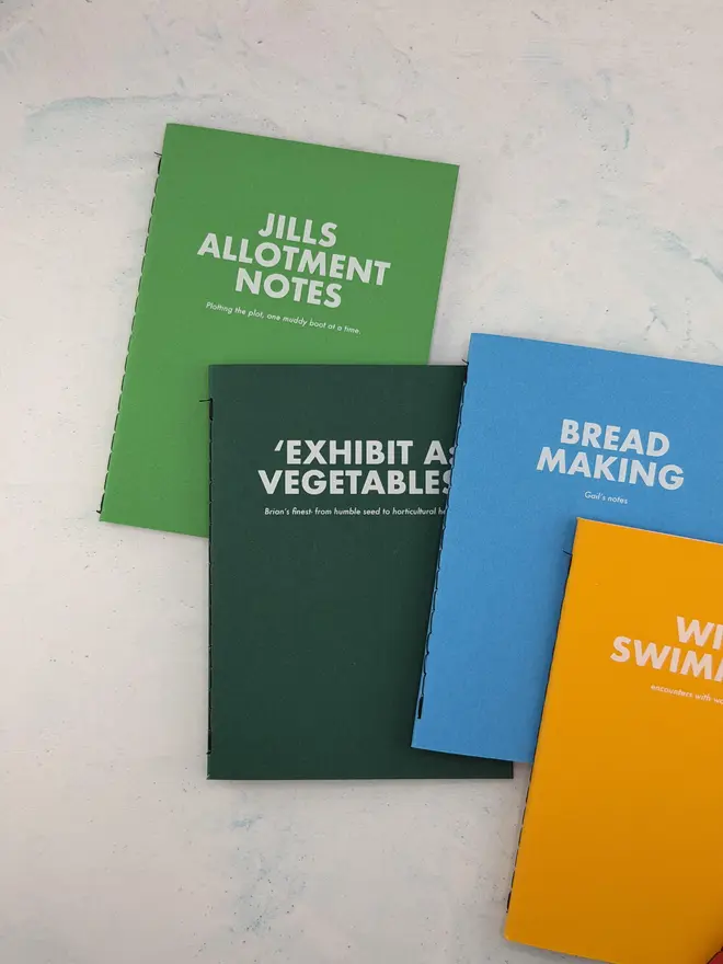 personalised notebooks personalised with "jill's allotment notes" "bread making" "wild swimming" "exhibit a:vegetables"