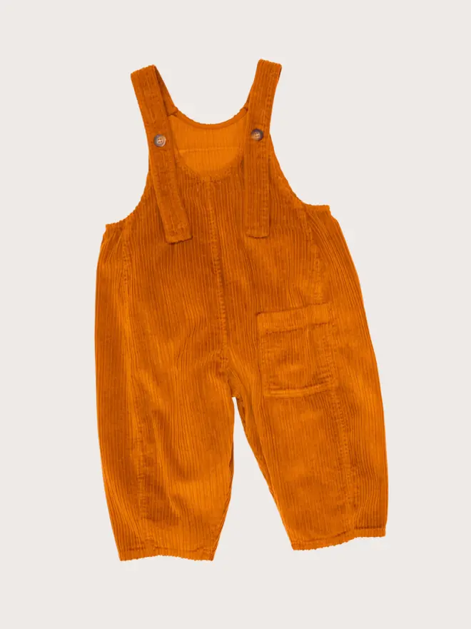 Back flat lay of Studio Koter Kai dungarees in brown corduroy, showing the flap patch pocket at the yoke.