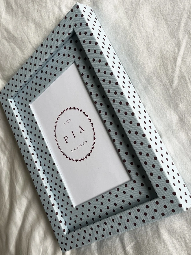 Blue & Burgundy Pembroke Dot Frame, a colourful dotted frame sitting on a plain white surface. 