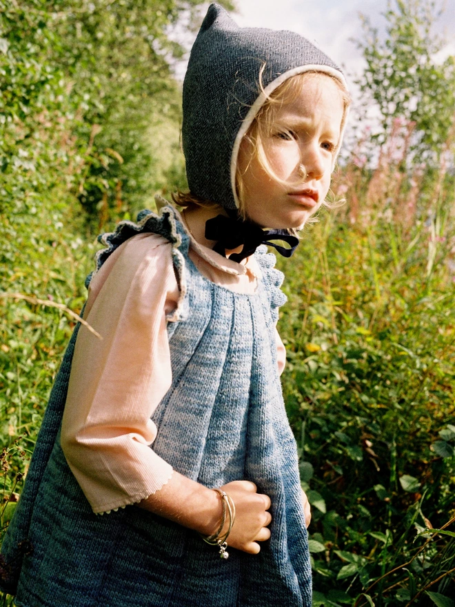 Blue pixie hat on girl outside