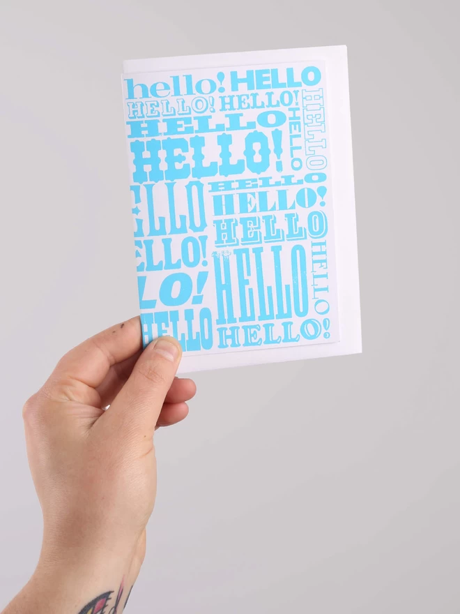 Blue Greetings Card with Hello written all over it in different fonts