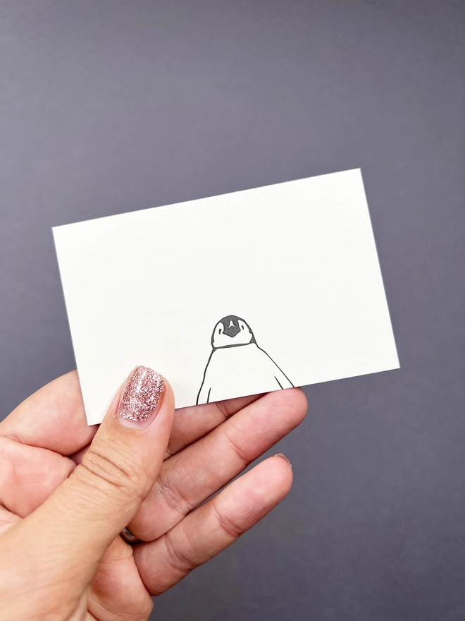 Letterpress tiny flat notelet printed with a baby penguin at the bottom