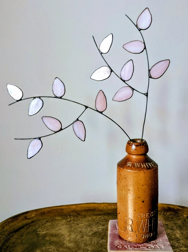 Pink glass flowers in bottle